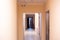 Entrance of an apartment building, long corridor in pastel colors. Purchase and inspection of real estate