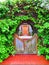 Entrance with arch, double wood swing half doors, red herringbone brick path, and greenery