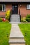 Entrance of average brown residential house built on land terrace