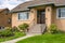 Entrance of average family house with green lawn in front