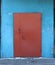 Entrance brown metal door in blue wall