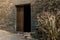 Entrance of a classic windmill with corn cobs leaning on the stone wall