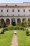 The entrance cloister of Monte Cassino Abbey and the death of Saint Benedict Statue. Monte Cassino, Italy