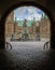 Entrance through a dark gate under an arch to Frederiksborg cast