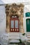 Entrance door with baroque decoration in the medieval town Ostuni in Puglia, South Italy