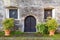 Entrance door and barred windows in ancient medieval building. Strassoldo, udine, Friuli, italy.