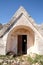 Entrance door of old abandoned Trulli house with multiple conical roofs in the area of Cisternino / Alberobello in Puglia Italy