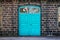 Entrance door to an old steel mill, building made of cinder stone