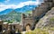Entrance door and wall of the ruins of Tourbillon castle and Sion hill and city panorama in background Sion Valais Switzerland