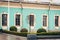 Entrance door and windows of an old blue baroque building with lawn, decorative tree and boxwood bushes, Mariinsky Palace in Kiev