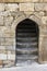 Entrance doorway in an ancient stone wall with stairs leading up.