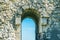 Entrance doorway in the stone wall, arch for entrance and exit in the ruins of the old city