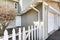 Entrance of duplex home with picket fence