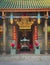 Entrance gate of a chinese buddhist temple in Saigon, Vietnam. The door is guarded by two Imperial lions made of stone.