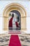 Entrance gate with red carpet to the orthodox pilgrimage church Panagia Evangelistria in Tinos town