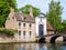 Entrance gate to Begijnhof, Beguinage, and bridge over canal in Bruges, Belgium