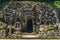 Entrance of Goa Gajah Elephant Cave with carvings of faces in Bali, Indonesia