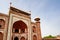 Entrance Great Gate to the Taj Mahal, India complex in a strong perspective view with blue sky