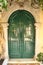 Entrance green door with cross