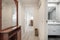 entrance hall of a house with a reddish wood sideboard and mirror,