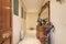 Entrance hall of a house with a sideboard with a turned wooden mirror and a full umbrella stand