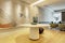 Entrance hall of a luxury house with a round table with vases, lattice