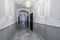 Entrance hallway to a residential block of flats with white marble flooring