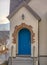 Entrance of home with stairs and arched blue door