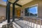 Entrance of a home with sunlit stairs and porch