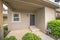 Entrance of a house with black front door and concrete doorsteps