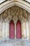 The entrance or main doors to an old English cathedral designed in the Gothic style
