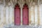 The entrance or main doors to an old English cathedral designed in the Gothic style