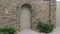 Entrance metal door and stone wall