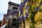 Entrance in old public pavilion on mountain Montjuic Barcelona Spain. Wisteria flowers decor on yellow wall