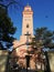 Entrance in the orthodox church Holly Trinity in Paracin, Serbia. A bird flying over the clear blue sky.