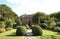 Entrance with a path, topiary trees, & eagle statues