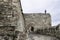 Entrance through the road that climbs to the Buda Castle, with the defensive wall and on top the Statue of the Virgin Mary