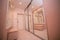 Entrance room with mirrors in beige, brown and white tones with white brick