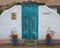 Entrance to adobe building with turquoise door