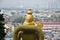 Entrance to Batu Caves with the giant, golden Murugan statue and the 272-step colorful staircase