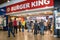 Entrance to Buger King fast food restaurant inside mall shopping centre service station setting with people