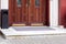 Entrance to the building with a wooden door and a marble threshold.