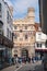 The entrance to Canterbury Cathedral in the sunshine. A school party is gathhered at the gate. The