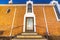 Entrance to church in Provo Utah with stairs and glass door under arched window