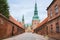 Entrance to Frederiksborg castle in Copenhagen, Denmark - September, 24th, 2015. Red brick fortress wall and green copper spiels
