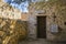 Entrance to the historic chapel at the cemetery on the leper island. Historic buildings in the Spinalonga fortress, Crete