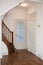 entrance to the house with the kitchen and living room doors and the stairs to the bedrooms