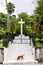 Entrance to Immaculate Conception Cathedral grounds, white stairs leading to the Holy Cross with tropical plants and palm trees