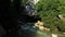 The entrance to Konglor cave hidden by rocks and tropical vegetation