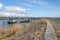 Entrance to Oosterhaven, city harbor with its dike, gates and a small anchored boat